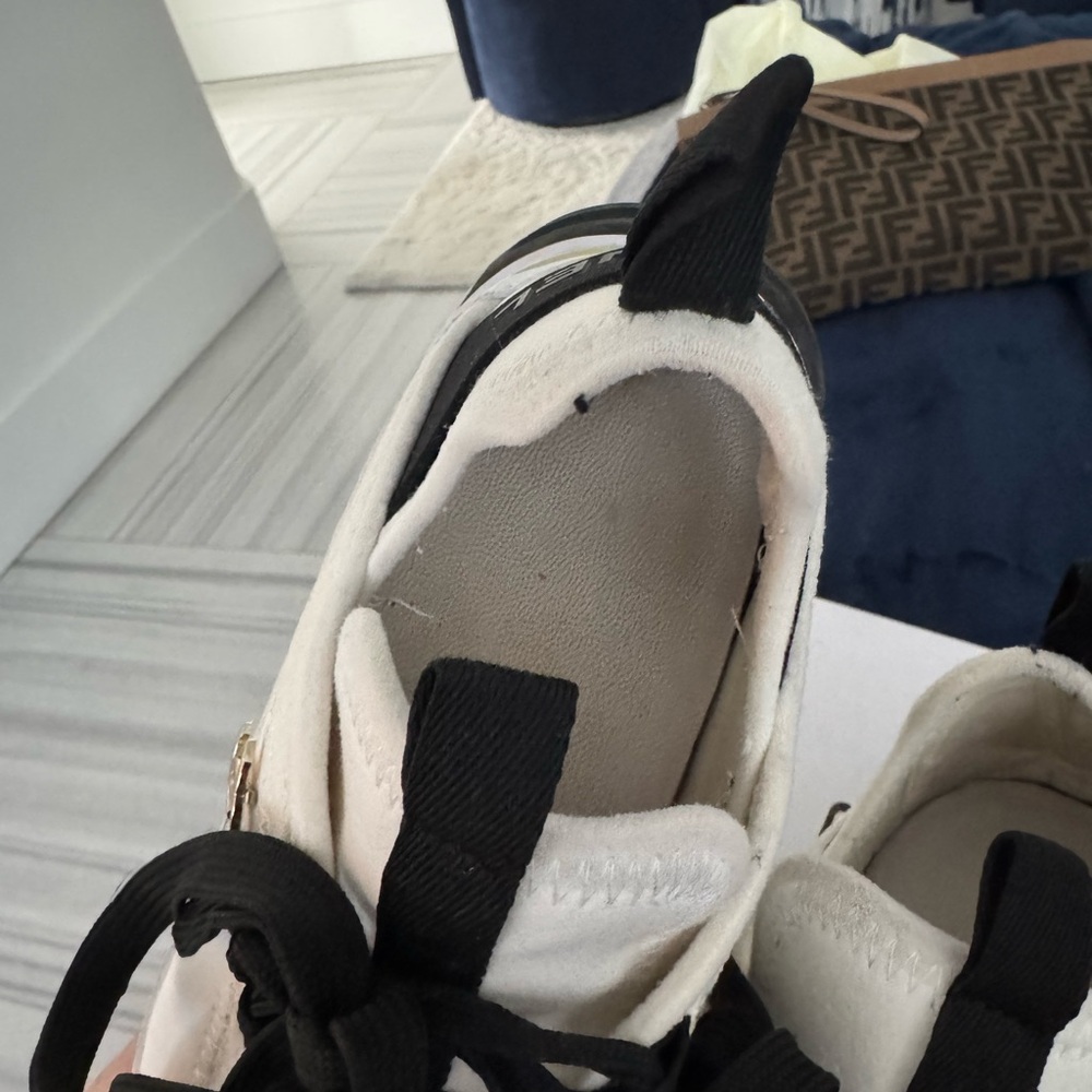 CHANEL White and Black Sneakers with Gold Accent - Picture 4 of 6